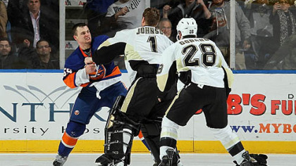 Islanders forward Micheal Haley fights Penguins goaltender Brent Johnson in the third period of Friday's game at Nassau Coliseum in Uniondale, New York as Penguins forward Eric Godard joins in.