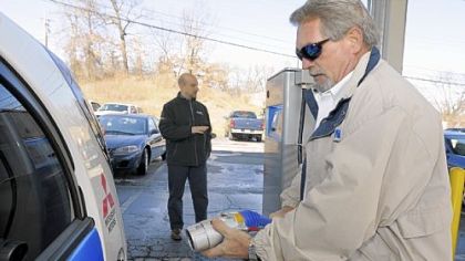 Eaton's Dale Jones hooks up a Mitsubishi all-electric car to the company's Type 3 commercial charging station.