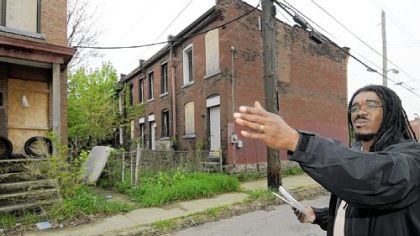 Jerome Jackson of Homewood's Operation Better Block at blighted row houses owned by a California company, RFS Investment LLC.