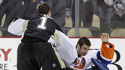 Penguins goaltender Brent Johnson knocks down Islanders goaltender Rick DiPietro with a punch in the third period of Wednesday's game at Consol Energy Center.