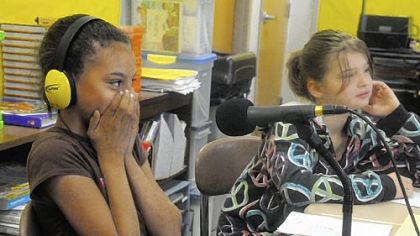 Kaylee Kendrick, 10, a fourth-grader of Homeville Elementary in West Mifflin, reacts after recording for the "Hear Me Project" at school while classmate Samantha Smidansky, 10, listens.