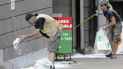 Third Avenue is dressed with artificial snow as the crew of "The Dark Knight Rises" prepares to film stunt scenes along Cherry Way in Downtown Pittsburgh.