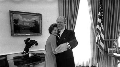 In this Dec. 6, 1974, photo provided by the White House via the Gerald R. Ford Library, President Gerald Ford and first lady Betty Ford embrace in the Oval Office.