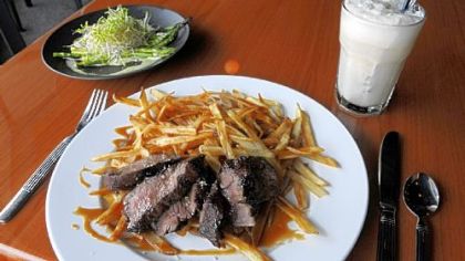 Steak frites with pork fat fries, an asparagus and sprouts salad with foie gras-hollandaise sauce and an ice cream soda at Bite Bistro in Bellevue.