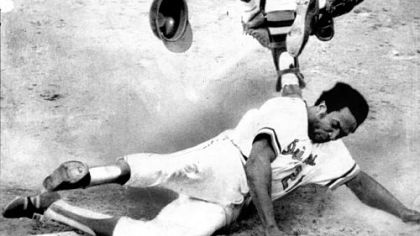 The Orioles' Frank Robinson scores the winning run of the sixth game of the 1971 World Series as he comes home on Brooks Robinson's 10th inning hit.
