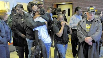 Danyelle Kelly-Cheatham, sister of slain Officer Eric G. Kelly, comforts her niece and Officer Kelly's daughter, Janelle Kelly, center in light shirt, at a gathering of about 30 people at Sunnyside Public school in Stanton Heights to mark the second anniversary of the shooting deaths of officers Kelly, Paul J. Sciullo II and Stephen J. Mayhle.