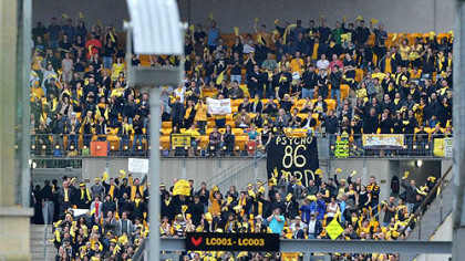 Extras cast as fans of the Gotham Rogues cheer at Heinz Field during filming of "The Dark Knight Rises."