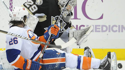 Penguins goaltender Marc-Andre Fleury makes a save on Islanders forward Matt Moulson in the third period of Tuesday's game at at the Consol Energy Center.