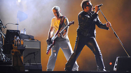U2's Adam Clayton, left, on bass guitar and Bono perform in the 360 World Tour at Heinz Field