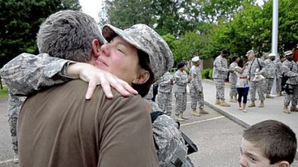 Moments before beginning her journey to the war in Afghanistan, Chris Cieslak gives husband Jeff a goodbye hug.