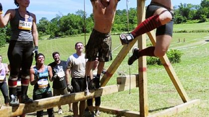 Stacey Keating, 25, right, makes it across the monkey bars at the Ruckus Pittsburgh event July 16.