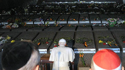Pope Benedict XVI (kneeling) prays during his visit Sunday at Rome's Ardeatine Caves, where 335 Italians were slaughtered by occupying Nazis on March 24, 1944.