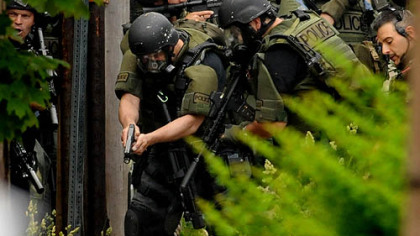 Pittsburgh's SWAT team converge on a man who was critically wounded by police during a standoff in Larimer.