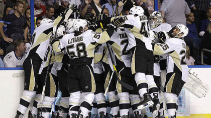 Penguins players mob forward James Neal after he scored the in the second overtime of Wednesday's Game 4 at the St. Pete Times Forum in Tampa, Fla.