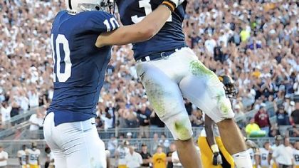 Penn State running back Joe Suhey, right, leaps into the arms of tight end Kevin Haplea after Haplea scored a touchdown, the only one of the game, against Iowa in the fourth quarter Saturday at Beaver Stadium.