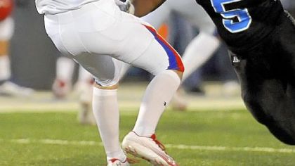 Ejuan Price, right, was a mainstay for last season's Woodland Hills defense.