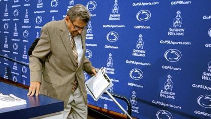 Coach Joe Paterno steps down from the stage after announcing at his weekly news conference that the Nittany Lions would stay with a two-quarterback system Saturday against Temple.