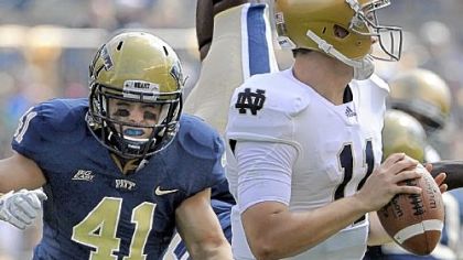 Pitt's Andrew Taglianetti gets pressure on Notre Dame quarterback Tommy Rees even as Todd Thomas is upended early in Saturday's game at Heinz Field.