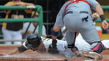Pirates first baseman Derrek Lee is tagged out by Cardinals catcher Yadier Molina.