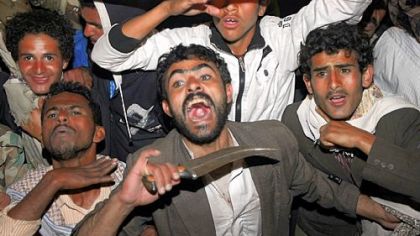 Yemeni anti-government protesters react Wednesday to the announcement that President Ali Abdullah Saleh would reliquish his office after 33 years in power.