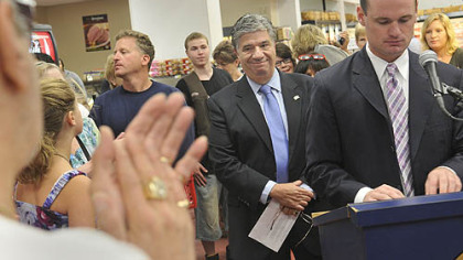 State Sen. Wayne Fontana, center, listens to Mayor Luke Ravenstahl talk about the new IGA supermarket.