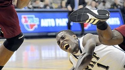 Pitt's Tray Woodall gets run over as he goes for the ball against Rider in the second half Sunday night at the Petersen Events Center.