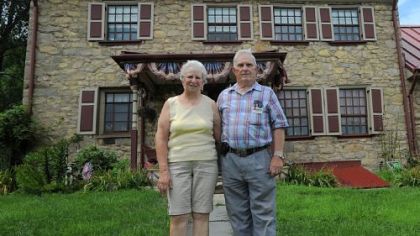 Bob and Marlene Cook stand outside their home in Belle Vernon built in the 1770s by Col. Edward Cook. The house has been in the Cook family for six generations. Bob Cook is keeping the stone house along with a second house and 16 acres of land, but he and family members who share ownership of the 300-plus acres of property have reluctantly decided to sell the rest.