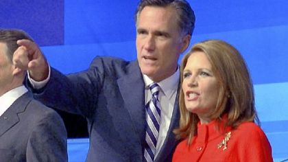 Former Massachusetts Gov. Mitt Romney points to the audience with Rep. Michele Bachmann, R-Minn, before a Republican presidential debate Thursday in Orlando, Fla.