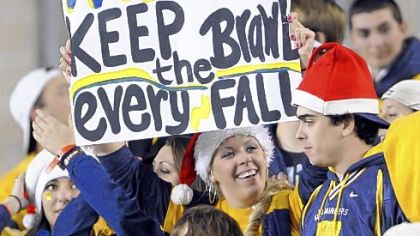 A fan shows her support for continuing the longrunning Backyard Brawl last night.
