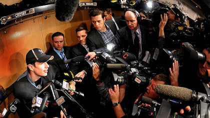Sidney Crosby is besieged by the media at his locker after workouts this morning at the Consol.