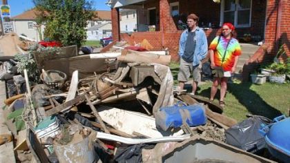 Josh and Carla Mankey look at the pile of their ruinned belongings in front of their apartment on Main Street in Houston, Pa., where their basement completely filled with water and the first floor was flooded from the remnants of Hurricane Ivan in 2004.