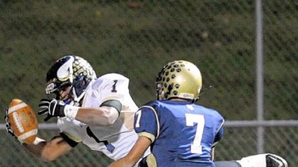 Hopewell running back Rushel Shell dives into the end zone to score a 64-yard touchdown in front of Franklin Regional's Cory Lauer in the second quarter Friday at Fox Chapel High School.