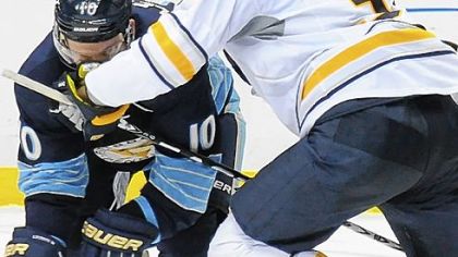 Mark Letestu is tied up by Buffalo's Patrick Kaleta in the third period.