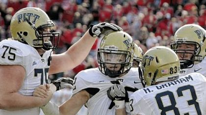 Teammates mob Tino Sunseri after he scores what proved to be the winning touchdown with 1:53 to play Saturday.