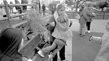 Raine Annan, 6, gives her mom, Christina, a bear hug as she waits for her four siblings to get out of school in Bellevue, where the family lives. Bob Annan supports his family working as a unionized Verizon salesman, but he wonders how long his family can maintain a middle-class lifestyle.