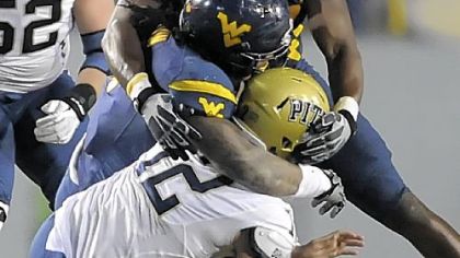 West Virginia's Bruce Irvin and Will Clarke sack Pitt's Tino Sunseri in the fourth quarter Friday.