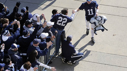 Penn State quarterback Matt McGloin greets fans as he enters Beaver Stadium before his team's game against Nebraska today.