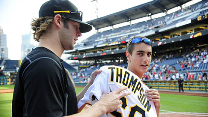 Pitcher Aaron Thompson signs away his jersey to Sam Sibeto of Tarentum, right, Sunday after the final game of the season at PNC Park. All players gave their jerseys away.