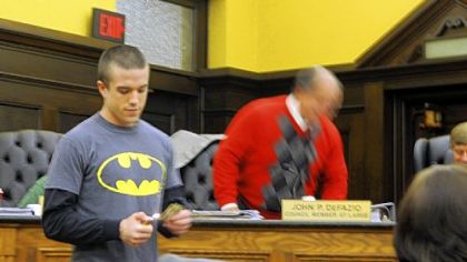 Max Langlois, student government president at CCAC South Campus, begins to light on fire a $20 bill that he had just received from Allegheny Council Councilman John P. DeFazio during the Allegheny County Council budget meeting on Thursday after Mr. Langlois had talked about budget difficulties: his own and the college's.