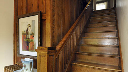 This staircase and paneling exemplify the Craftsman-style woodwork throughout the house.