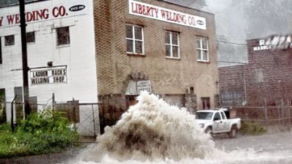 Floodwater gushes from a manhole cover Aug. 19 along Washington Boulevard.