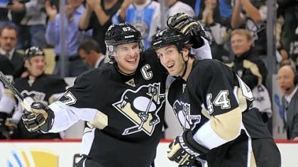 Penguins' Sidney Crosby celebrates with Brooks Orpik after assisting on a  goal.