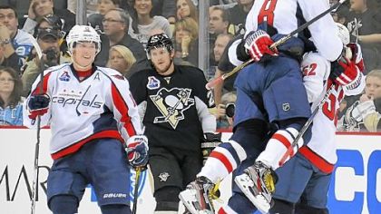 The Capitals celebrate a power-play goal by Dennis Wideman at 2:48 in overtime Thursday at Consol Energy Center