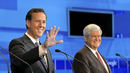 Republican presidential candidate former Pennsylvania Sen. Rick Santorum, left, waves to a member of the audience as former House Speaker Newt Gingrich looks on.