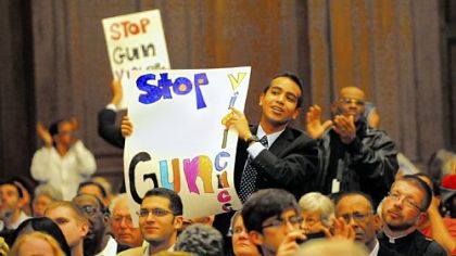 Rashed Harun of Squirrel Hill displays his sign and feelings during the Pittsburgh Interfaith Impact Network public action meeting Thursday at Rodef Shalom Congregation in Shadyside.