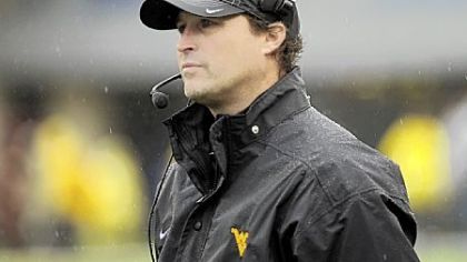 West Virginia coach Dana Holgorsen watches during a rainy first quarter of an NCAA college football game against Bowling Green on Saturday in Morgantown, W.Va.