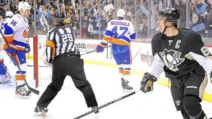Sidney Crosby celebrates after scoring in the first period against the Islanders Monday at Consol Energy Center.