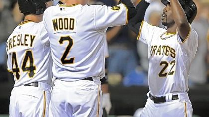 Andrew McCutchen celebrates with Alex Presley and Brandon Wood after his three-run homer.
