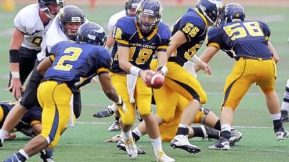 Central Catholic quarterback Perry Hills hands the ball off to Damian Jones-Moore against Archbishop Wood at the Gateway Kickoff Classic Sunday in Monroeville. Jones-Moore rushed for 189 yards and two scores.