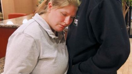 Deborah Bradley, left, and Jeremy Irwin embrace while in the lobby of a Hampton Inn hotel in Kansas City, Mo., Friday.